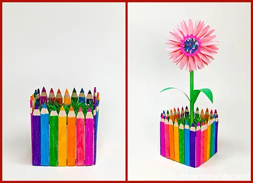 Bunt bemalte Buntstifte, die zu einem quadratischen Behälter zusammengefügt sind, daneben derselbe Behälter mit einer pinken Papierblume darin