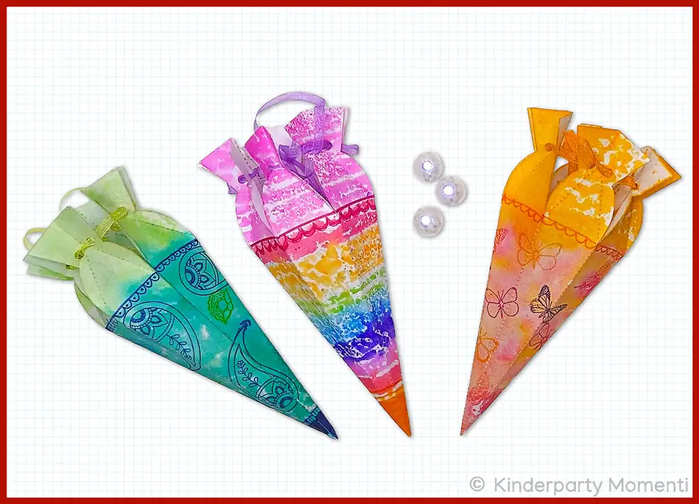 Ballonlichter für Minischultüten Auf einem Tisch lliegen drei kugelförmige Ballonlichter neben drei selber gebastelten kleinen Schultüten.