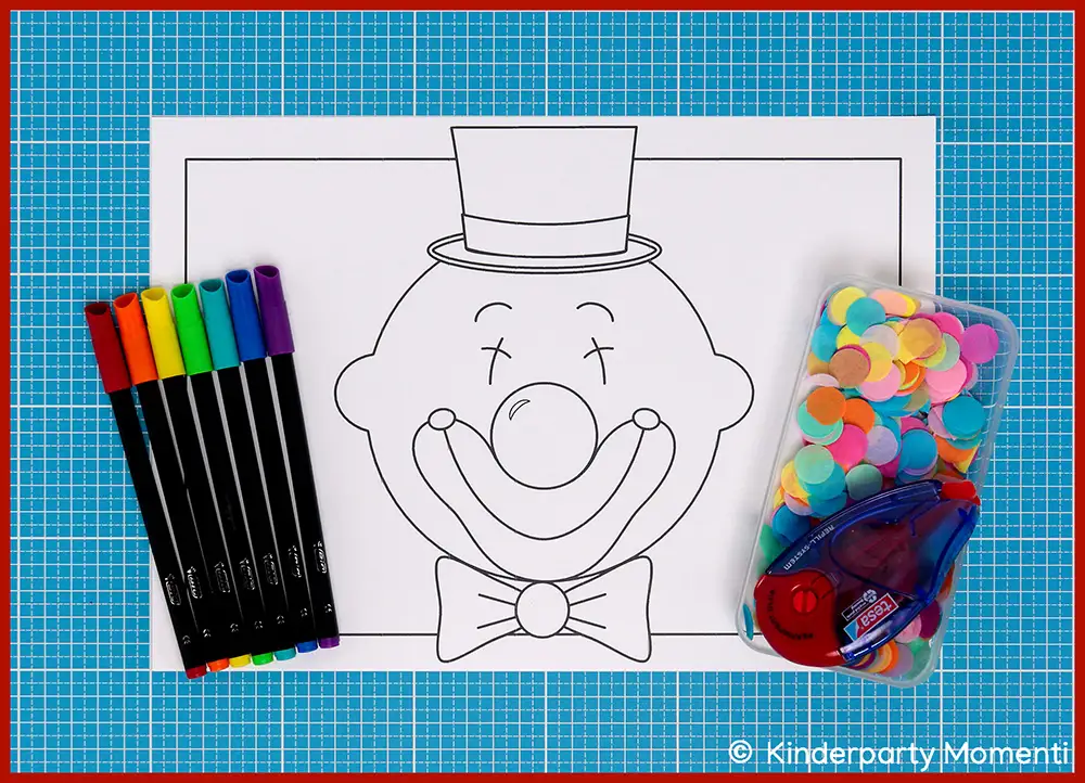 Clown Vorlage ohne Haare mit Zylinder und Fliege, daneben bunte Filzstifte, bunte Konfettis und Kleberoller auf blauem Schneideunterlage