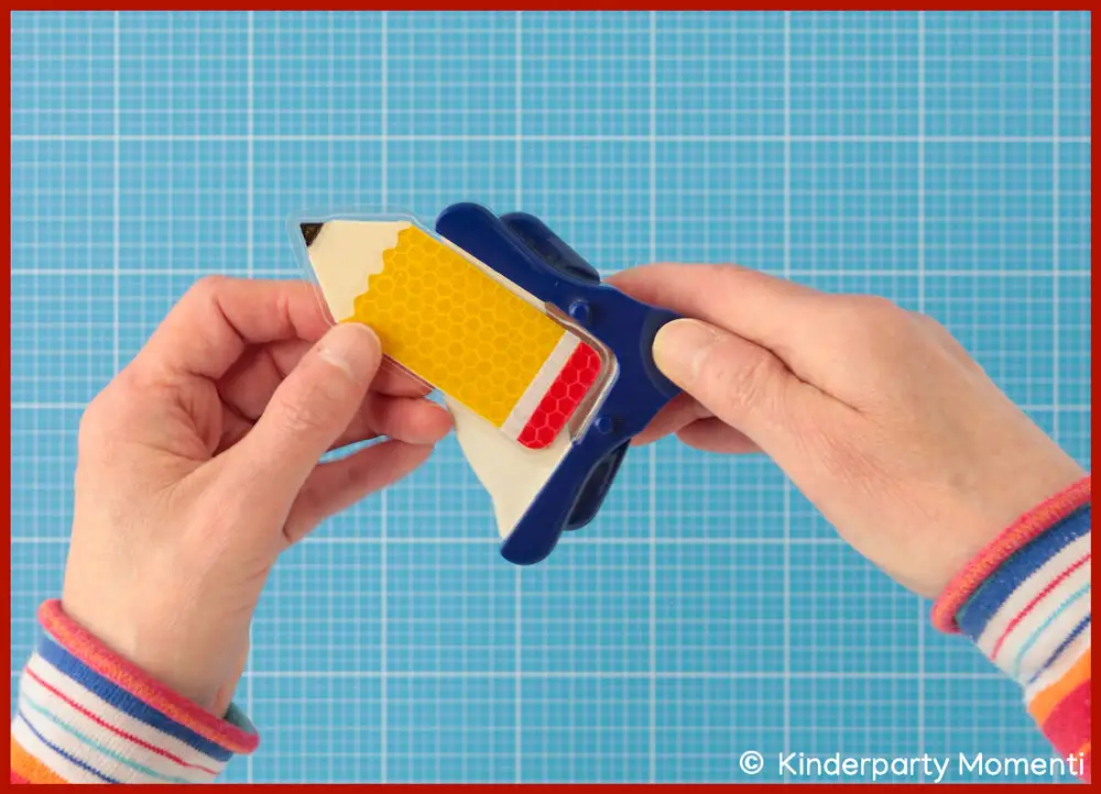 Anhänger - Kanten abrunden Hände die Ecken am Bleistift Anhänger aus Reflektorband abrunden